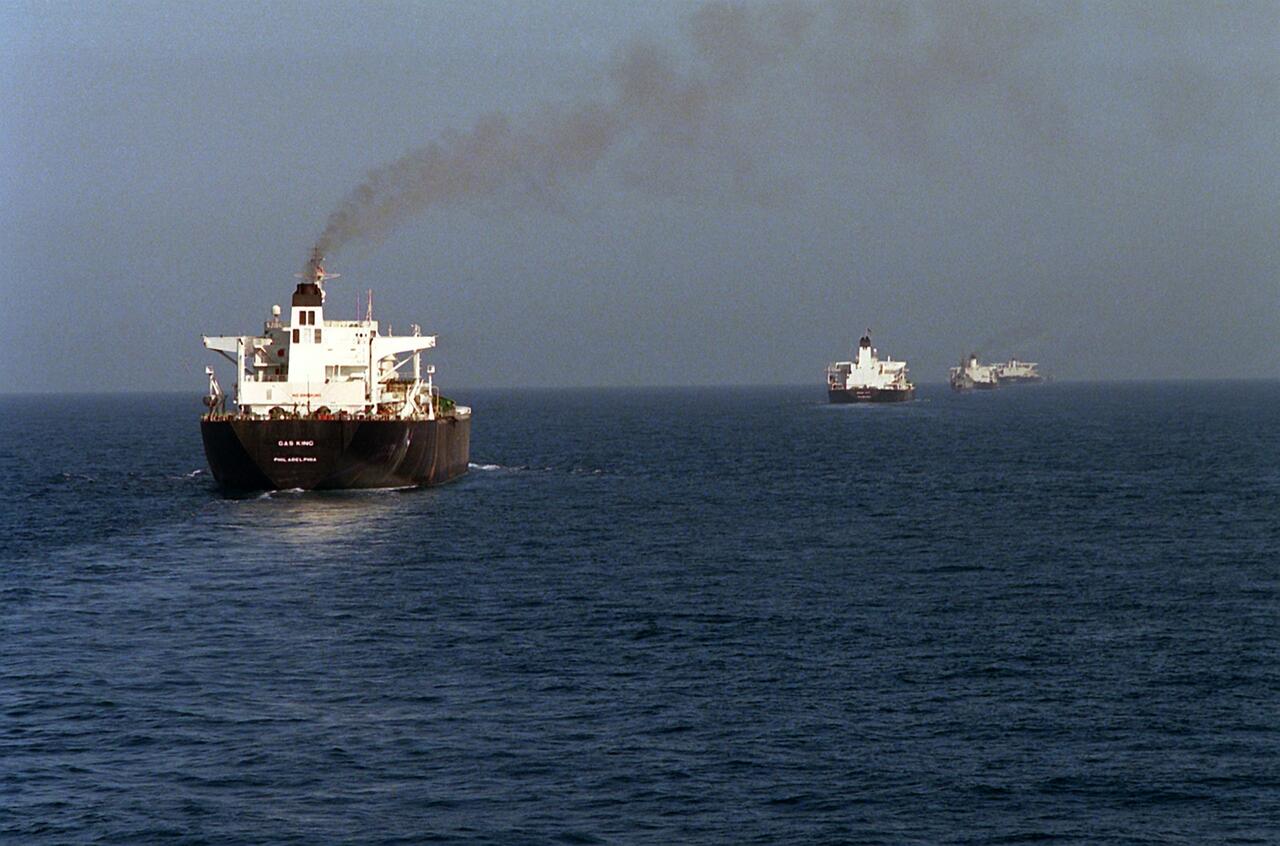 Four reflagged Kuwaiti oil tankers in convoy, escorted by U.S. Navy ships through the Persian Gulf during Operation Earnest Will, 1987.