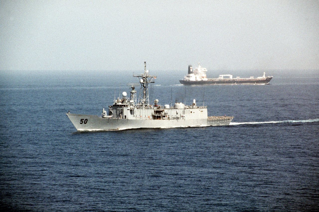 The guided-missile frigate USS Taylor escorts an oil tanker through the Strait of Hormuz during Operation Desert Shield.